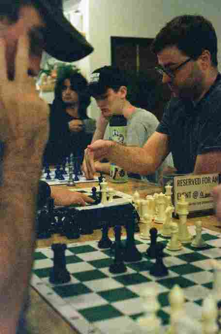 father_nathan_playing_chess_with_community